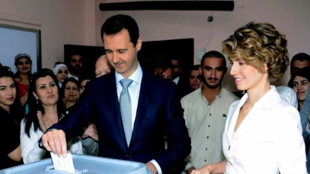 Assured to win: Syrian President Bashar al-Assad and his wife Asma vote in the election.