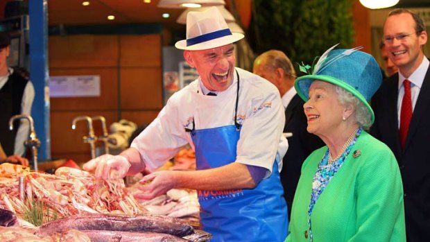 Queen Elizabeth meets fishmonger Pat O’Connell at Cork’s English Market during her historic visit to the Irish Republic.
