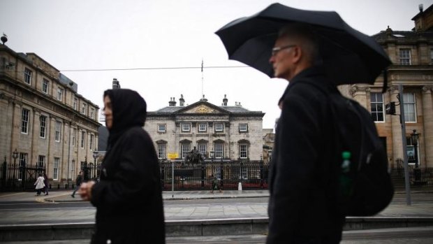 Gods that failed: Pedestrians walk past the Royal Bank of Scotland's headquarters in Edinburgh.