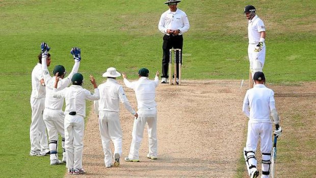 Disbelief: The Australian players look on after Umpire Aleem Dar turned down an appeal against Stuart Broad.