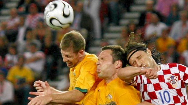 Scott Chipperfield (L) and Mark Viduka of the Socceroos jump for the ball with Niko Kovac of Croatia during the 2006 World Cup clash.