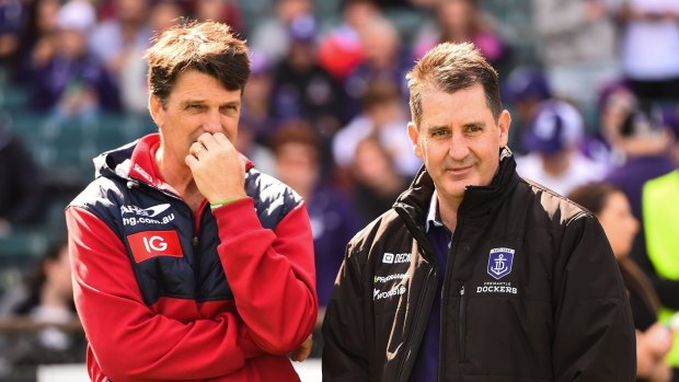 Melbourne coach Paul Roos and Fremantle coach Ross Lyon exchange views on Sunday.