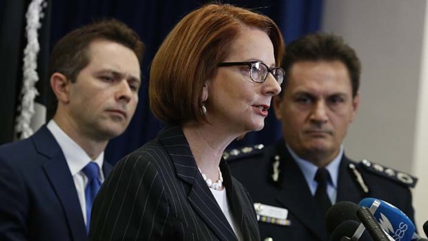 Prime Minister Julia Gillard announces the new anti-gang taskforce at a press conference with AFP Commissioner Tony Negus and Home Affairs minister Jason Clare.