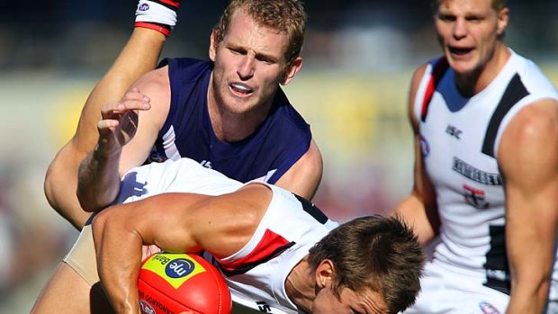 Gotcha: Sean Dempster is tackled by Fremantle's David Mundy during the Saints' 46-point win at Patersons Stadium.