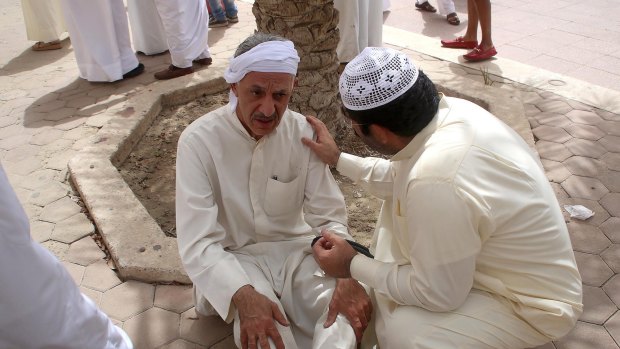 A Kuwaiti man reacts at the site of the suicide bombing.