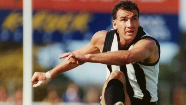 One of the great Darrens: Darren Millane launches the ball forward for Collingwood.