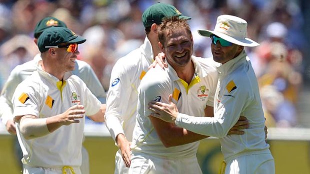 Success: Ryan Harris celebrates the wicket of England's Joe Root.