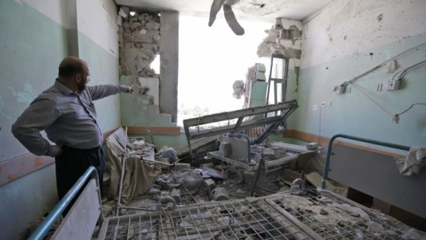 Afif Quneibi, a Palestinian orthopaedic specialist, inspects the damage to a patient room at the al-Aqsa Martyrs hospital, caused by Israeli strikes on July 21, in Deir al-Balah.