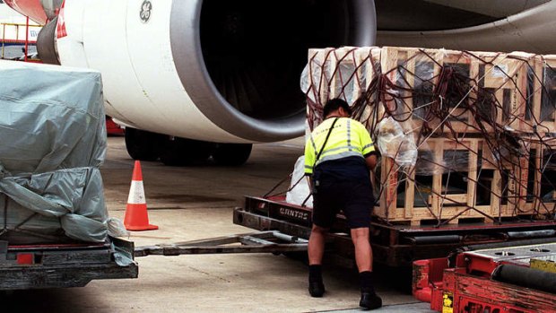 Figures don't stack up: Cargo is loaded onto a Qantas plane in what is a sluggish market.