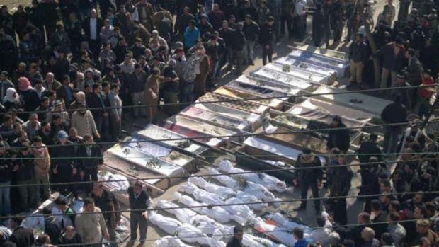 Mourners gather at the funeral  of  victims reportedly killed on Saturday  in  Homs province.