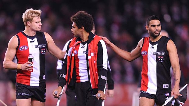 Chin up: Nick Riewoldt (left) and Raphael Clarke console injured teammate Jimmy Gwilt.