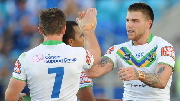 Josh Dugan of the Raiders celebrates with Travis Waddell (obscured) and Josh McCrone (7) during the round two NRL match between the Gold Coast Titans and the Canberra Raiders at Skilled Park on March 10, 2012 in Gold Coast, Australia.  (Photo by Matt Roberts/Getty Images)