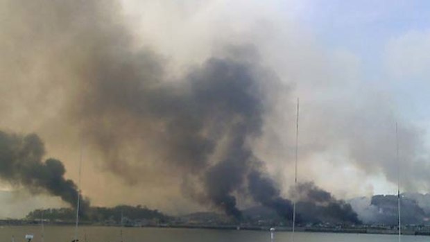 Flashpoint . . . smoke billows from houses on Yeonpyeong island after the North Korean artillery barrage.