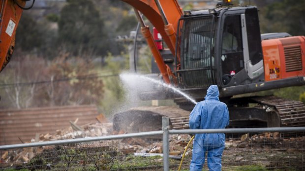 Workers demolish a Mr Fluffy home in Woden valley. 
