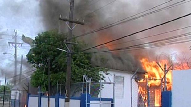 A police station in West Kingston burns.