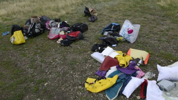 Passengers' belongings lie at the crash site of MH17. There has been multiple reports of looting.