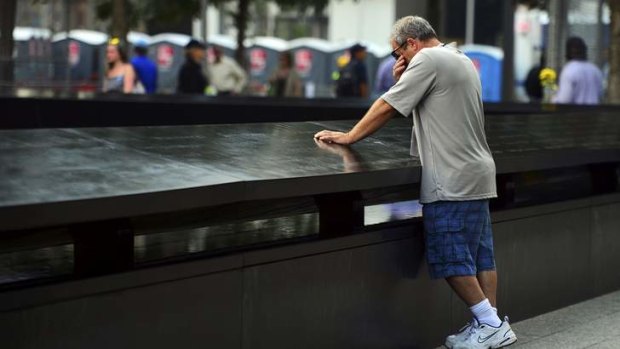 TJ Neary pauses at Ground Zero to remember his mother Mauriel Siskocoulos.