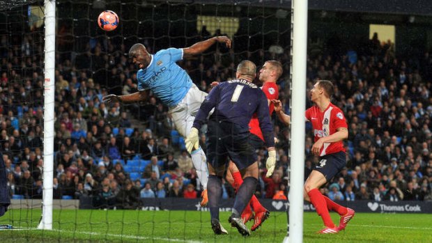 City's Micah Richards heads the ball wide of the goal.
