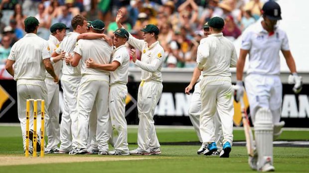 One down: Peter Siddle and the Australians celebrate after taking the wicket of Alastair Cook.