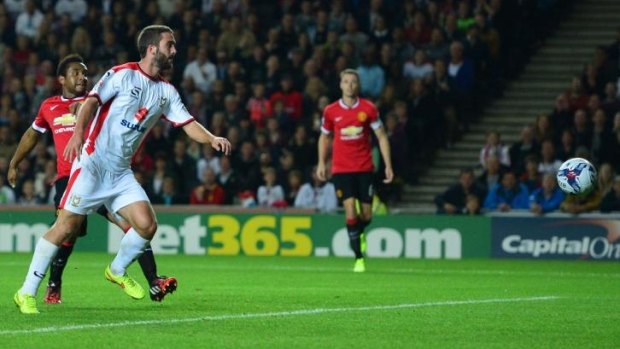 Will Grigg scores the second goal for the MK Dons.