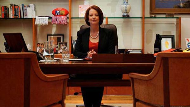 Prime Minister Julia Gillard resumes her seat in her suite at Parliament House.
