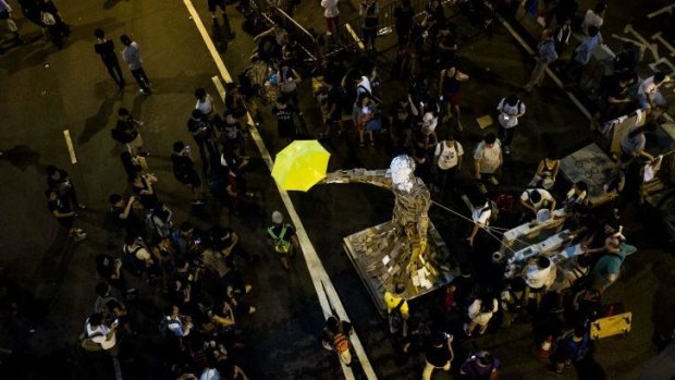 Umbrella Man by the Hong Kong artist known as Milk stands at a pro-democracy protest site next to the central government offices in Hong Kong.