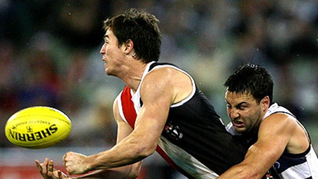 St Kilda’s Lenny Hayes is tackled by Jimmy Bartel of Geelong in the round-13 clash won by the Saints.