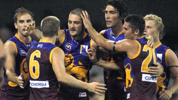 Brendan Fevola is congratulated by teammates at the Gabba.