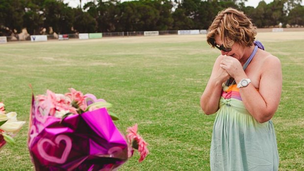 Luke Batty's mother, Rosie Batty, visits the oval where her son was killed by his father.