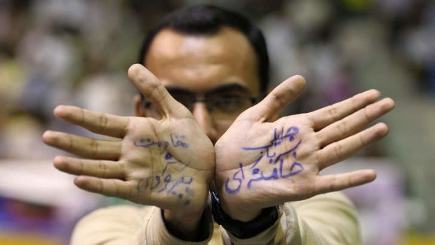 Hand up: A supporter of Saeed Jalili displays his hands with a phrase reading in Farsi, "Jalili soldier of Khamenei".