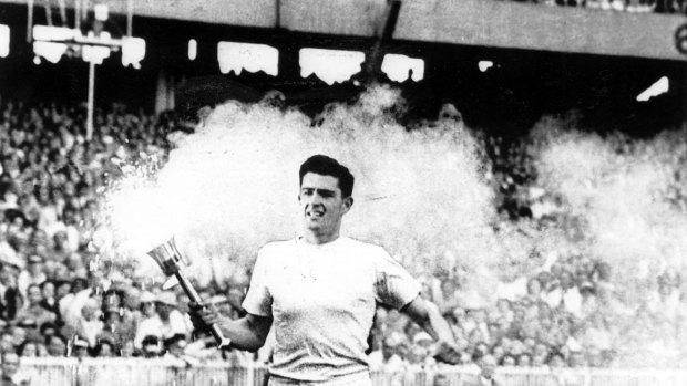 Ron Clarke carries the torch / flame around the MCG during the opening ceremony, 1956.