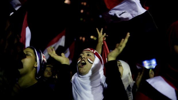 Jubilation: Opponents of Egypt's Islamist leader Mohammed Mursi celebrate outside the presidential palace in Cairo.