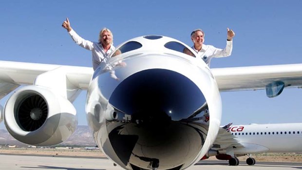 Virgin Galactic founder Sir Richard Branson, and Scaled Composites LLC founder Burt Rutan wave from the mothership aircraft White Knight Two.