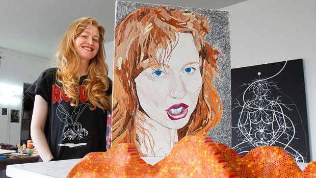 Fair exchange ... artist Nell in her studio with works she has swapped with fellow artists, including a study of Richard Larter’s portrait <i>Nell 15</i>, an Archibald finalist in 2009, and a Lionel Bowden sculpture.
