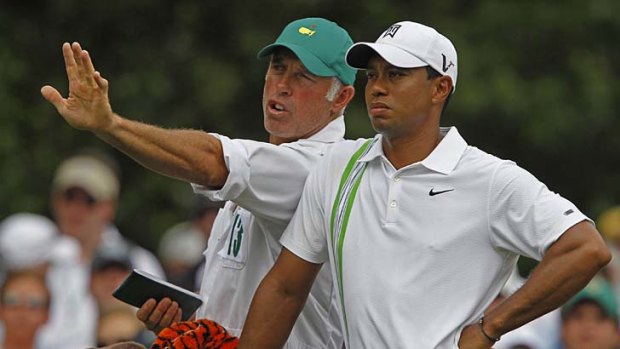 Tiger Woods (R) of the U.S. talks with his caddie Steve Williams (L) at the 2011 Masters.