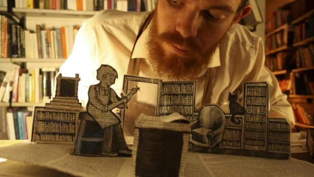 Interesting props: Ralph McCubbin performs The Bookbinder using pop-up books and paper art.