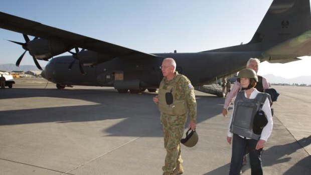 Prime Minister Julia Gillard and Chief of the Defence Force General David Hurley (left), disembark a C-130 aircraft at Kabul Airport after visiting the Multi-National Base in Tarin Kowt.