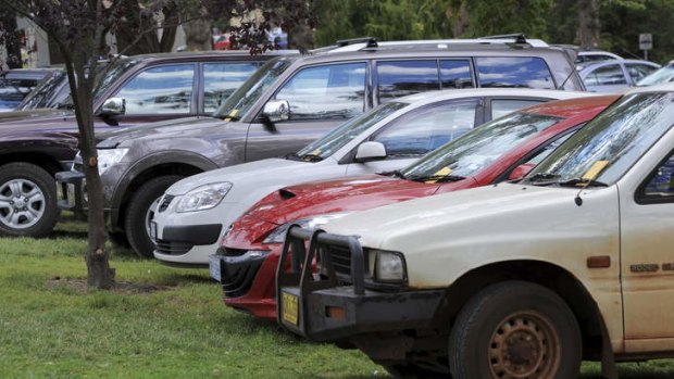 These vehicles were fined for being parked on the grass in Telopea Park.
