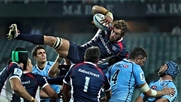Rebel with a cause: Scott Higginbotham wins a lineout against the Waratahs on Friday night in Sydney.