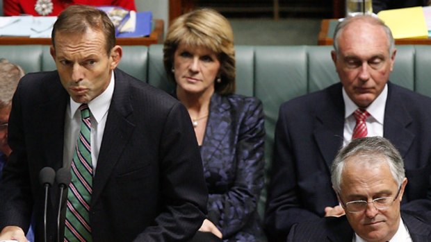 Showing his support ... Tony Abbott speaks during Question Time yesterday, flanked by Malcolm Turnbull, front right.