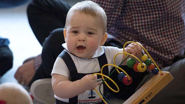 Paly time: Prince George tries out a toy.