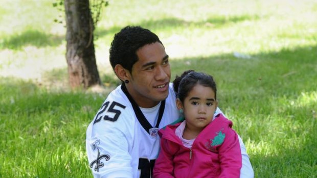 Brumbies player Joe Tomane relaxes in Telopea Park with his daughter,  three-year-old Starsha.