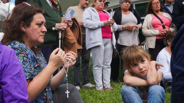 People pray for the crew of the missing submarine.