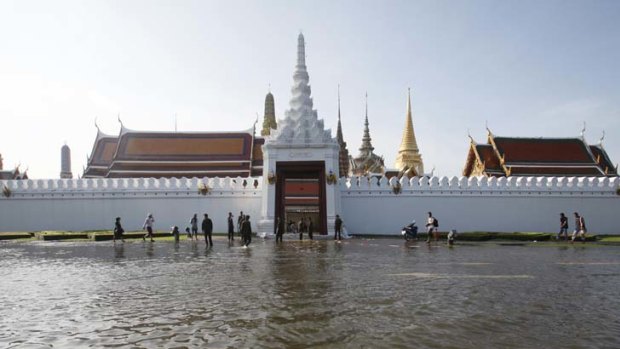 Closing in ... floodwaters surround the landmark Grand Palace, in the heart of Bangkok's royal precinct. The Prime Minister has warned the flooding could last for a month.