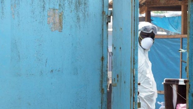 Door into danger: A health worker in the high risk area of the John Fitzgerald Kennedy hospital in the Liberian capital, Monrovia.