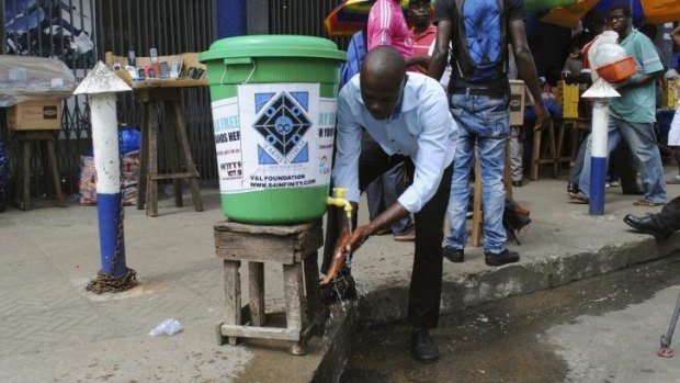 A man washes his hands as a preventive measure in Monrovia.