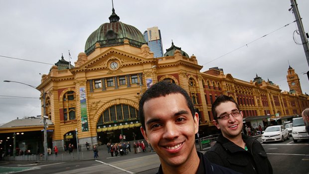 Melbourne University students Manuel Pineda (left) and Santiago Medina in front of the Flinders Street train station.