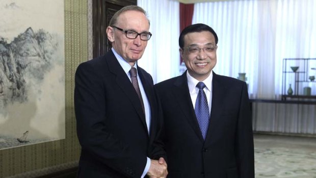 Pick your godfather ... Australian Foreign Minister Bob Carr shakes hands with Chinese Vice Premier Li Keqiang during a meeting in Beijing yesterday.