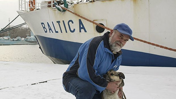 Adam Buczynski  with the dog found floating alone on an ice floe  off the Polish coast.