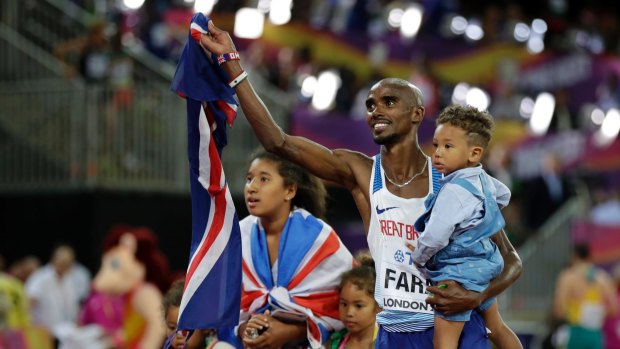 Time to celebrate: Farah takes his family for his lap of honour.